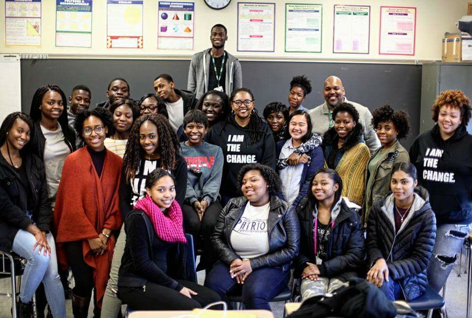 Group of young women and men in classroom