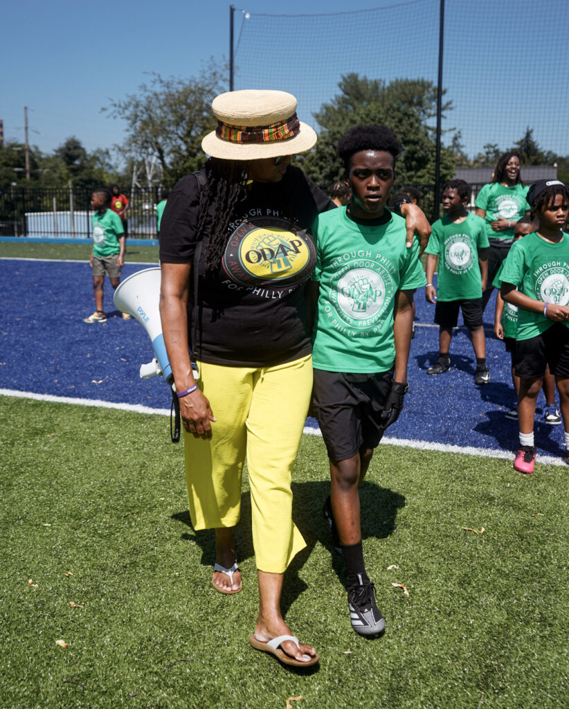 Valencia “Coach V” Peterson walking with a young teenage boy